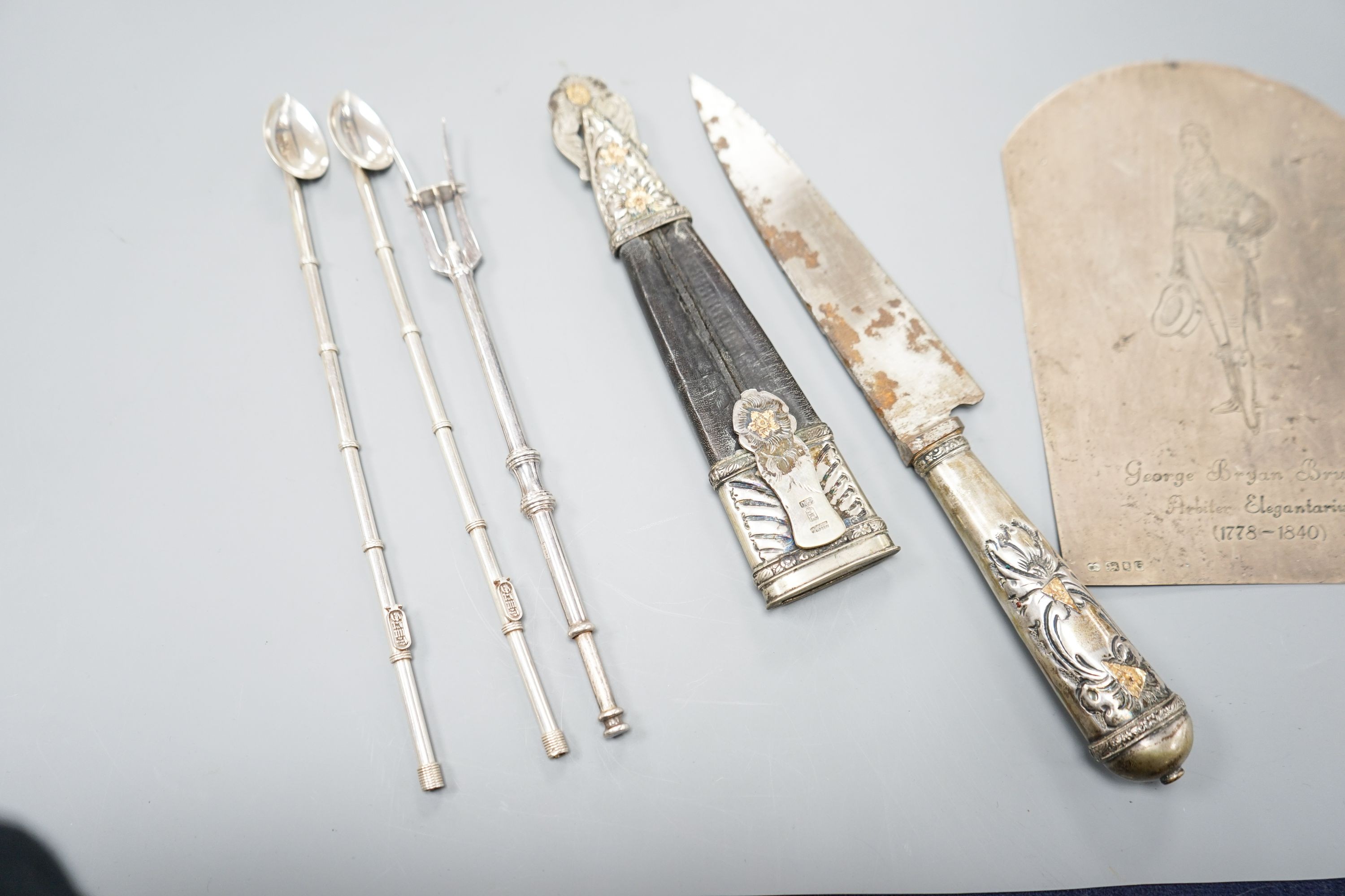 A silver plaque, two mate straws, knife etc.